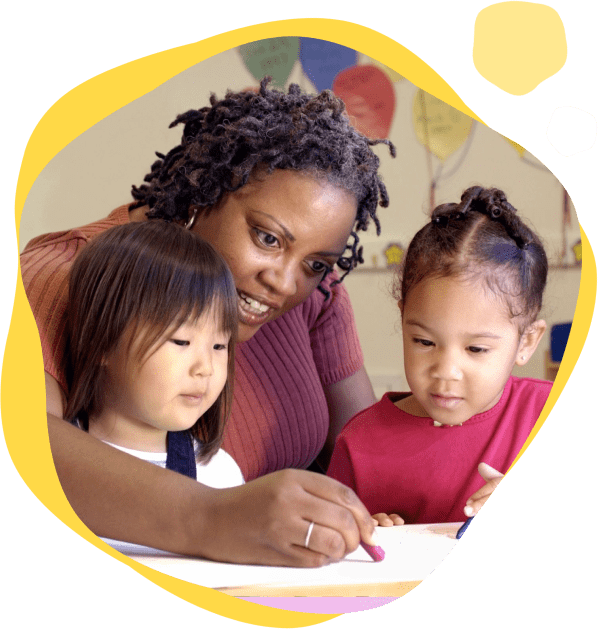 A woman and two children are writing on paper.