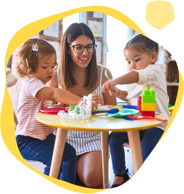 A woman and two children playing with toys.